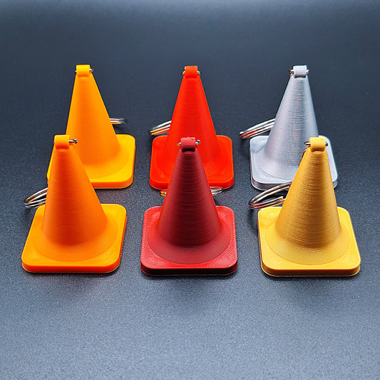 Side-by-side display of six colorful traffic cone keychains, showing detailed shape and eco PLA material, ideal for gag gifts or themed sets.