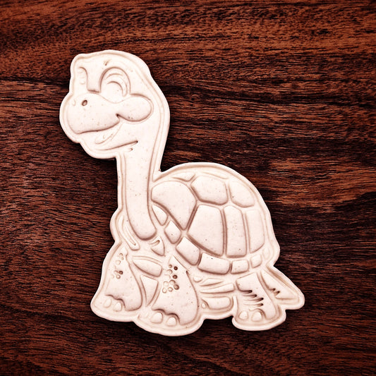 Cookie dough stamped with turtle design showing shell and flippers, made with matching cutter and detail stamp from our sea turtle set.
