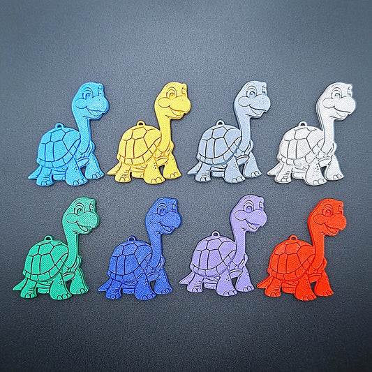 Front view of eight turtle keychains in vibrant colors, handmade from sustainable PLA plastic—ideal marine gifts for ocean lovers and kids.