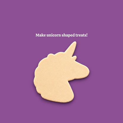 A unicorn-shaped cookie cutout on a solid purple background, with the white text 'Make unicorn shaped treats!' above it.