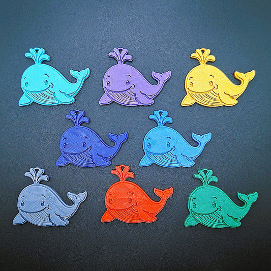 Colorful whale keychains in 8 shades, handmade eco-friendly ocean-themed charms, perfect for marine lovers and sea life accessory fans.