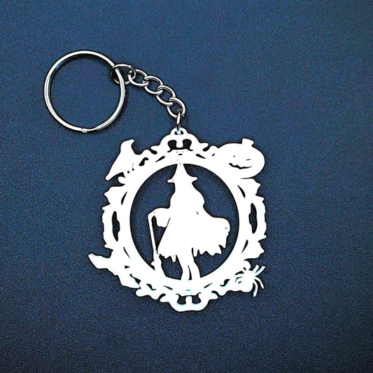 Spooky witch keychain charm with festive Halloween border of pumpkin, bat, crow, and spider, handmade accessory for keyrings and bags.