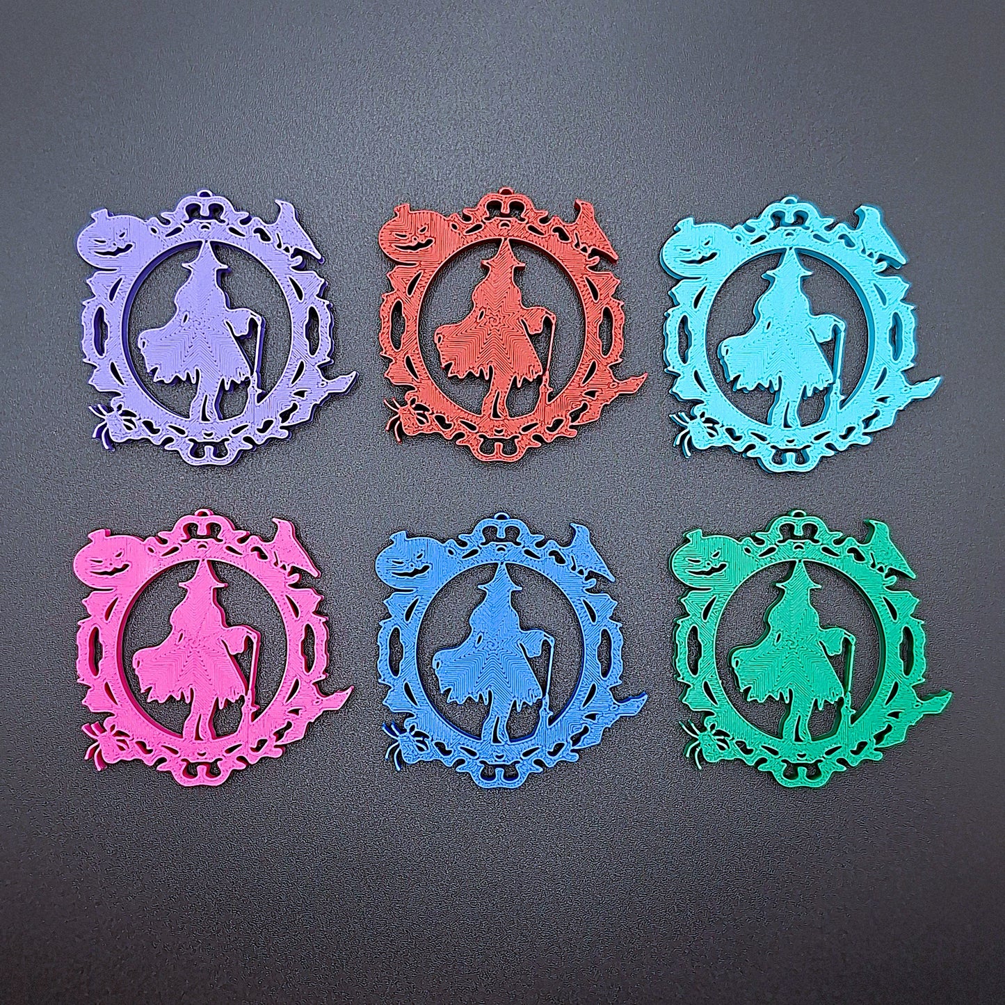 Eco-friendly witch keyrings featuring detailed Halloween icons including broom, pumpkin, spider, bat, and crow, great for gifts or favors.