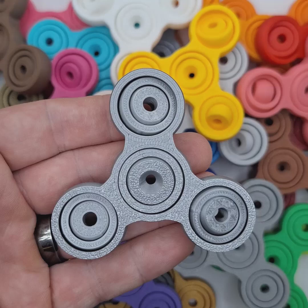 Video showing mini fidget and gyro spinners in various colors, great for ADHD, anxiety, stress, and focus. Perfect for gifting, party favors and classroom prizes.
