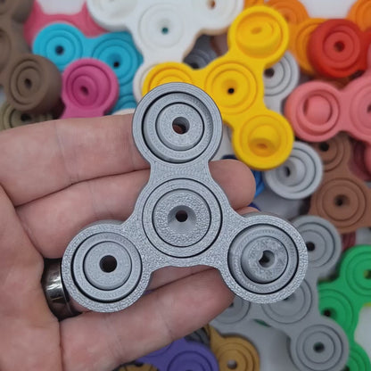 Video showing mini fidget and gyro spinners in various colors, great for ADHD, anxiety, stress, and focus. Perfect for gifting, party favors and classroom prizes.