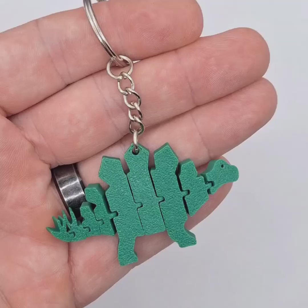 Video showing the articulated stegosaurus dino keychain from multiple angles and jointed features, perfect for classroom prizes and birthday party favors.