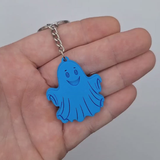 Video showing a ghost keychain in cyan, perfect for Halloween party favors and trick or treats.